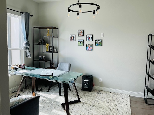 office space with wood finished floors and baseboards