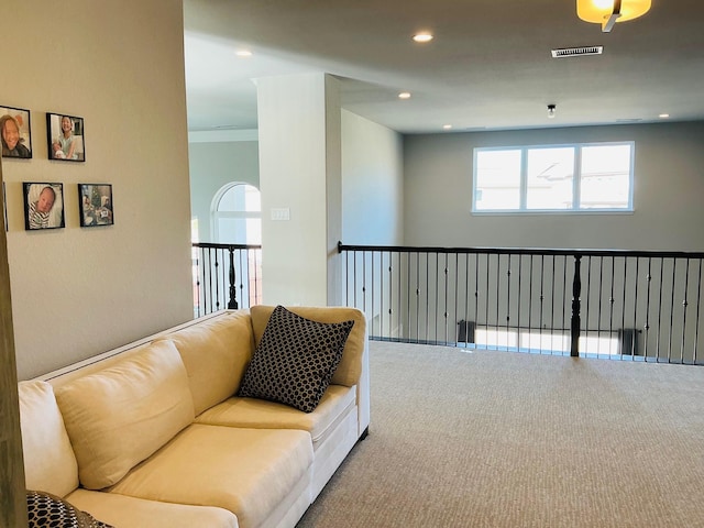 carpeted living room with visible vents and recessed lighting