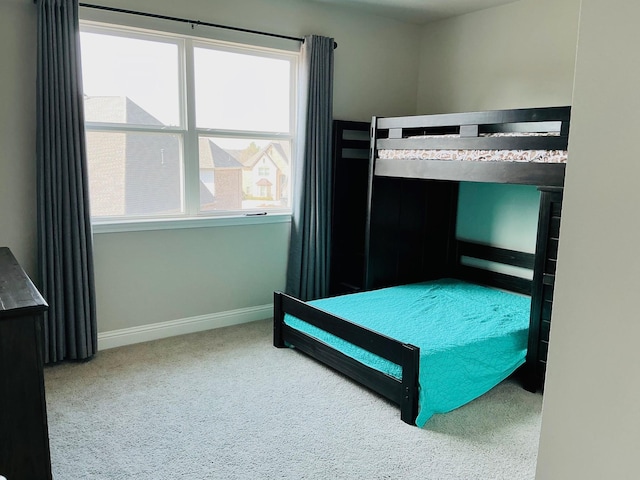 bedroom featuring carpet floors and baseboards