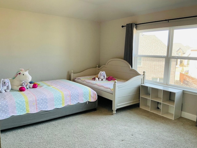 carpeted bedroom featuring baseboards