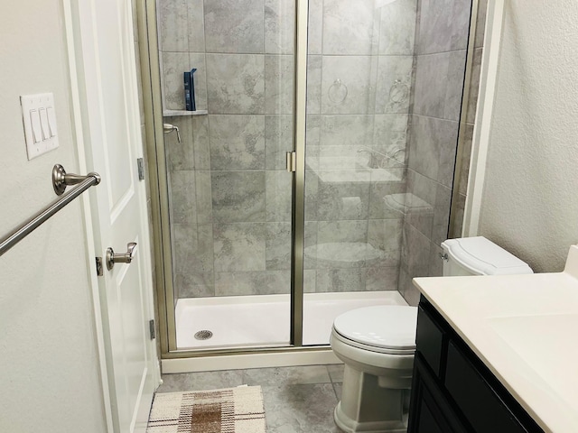 full bathroom featuring toilet, a shower stall, and vanity