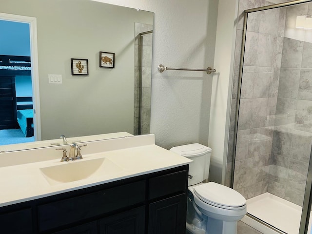 full bath with a stall shower, vanity, and toilet