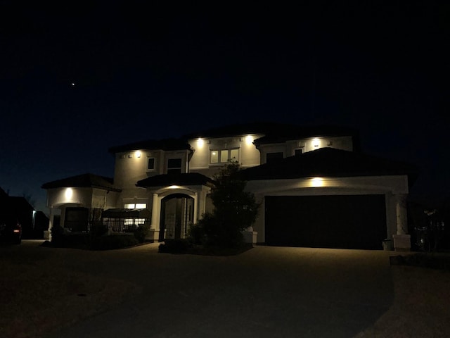 view of front of home with a garage and french doors