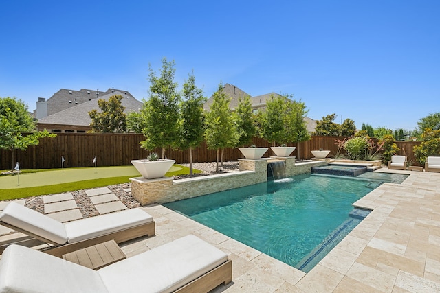 view of swimming pool with a patio area, a fenced backyard, and a pool with connected hot tub