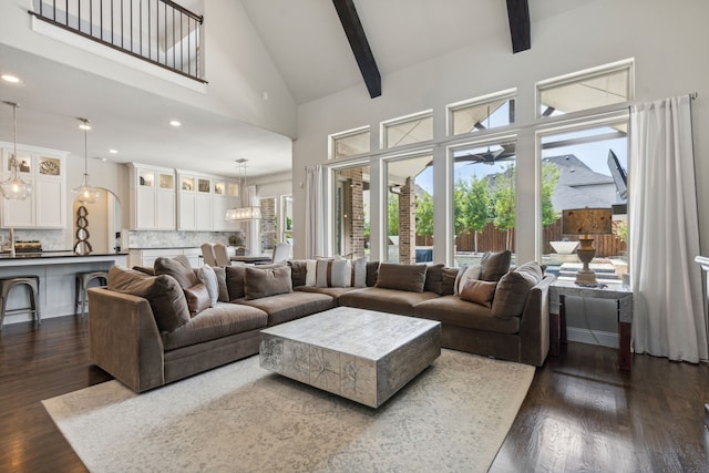 living area featuring beam ceiling, high vaulted ceiling, dark wood-type flooring, and recessed lighting