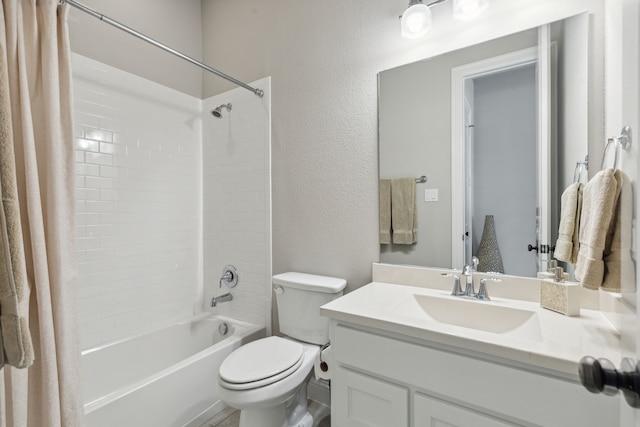 full bathroom with a textured wall, shower / bath combo, vanity, and toilet