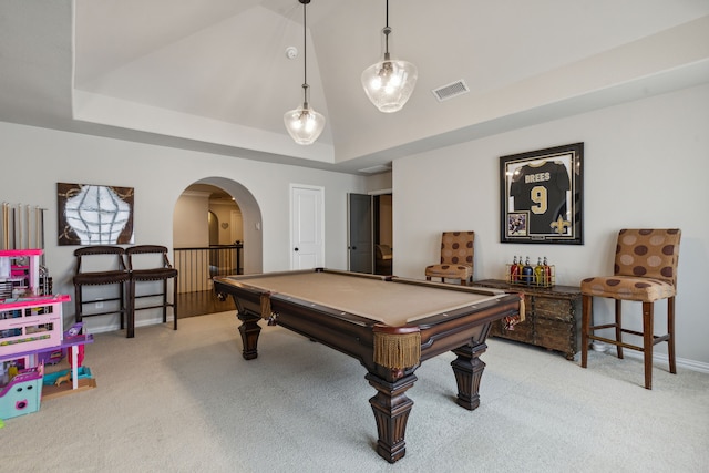 game room featuring carpet floors, visible vents, arched walkways, and a tray ceiling