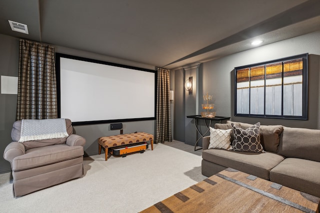 cinema room featuring visible vents and carpet flooring