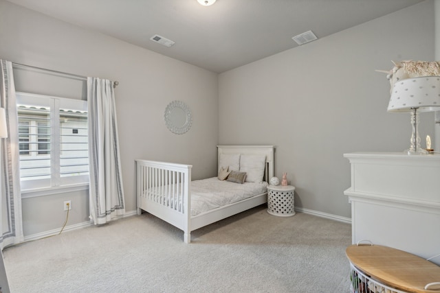 carpeted bedroom with baseboards and visible vents