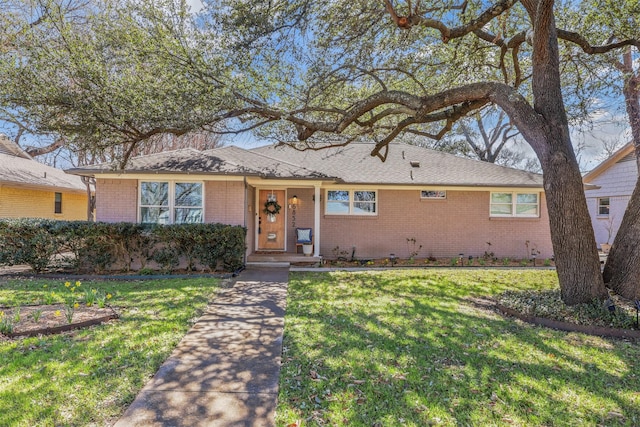 ranch-style house with brick siding and a front yard