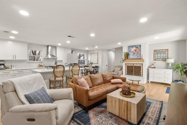 living room with dark wood-type flooring, recessed lighting, and visible vents