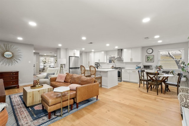 living area featuring a toaster, recessed lighting, visible vents, and light wood-style floors