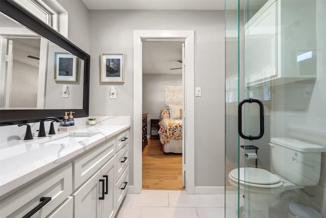 ensuite bathroom with vanity, ensuite bath, toilet, and tile patterned floors