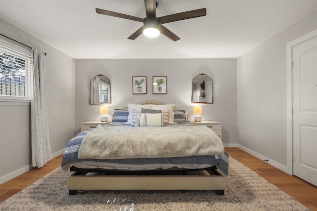 bedroom featuring baseboards, a ceiling fan, and light wood-style floors