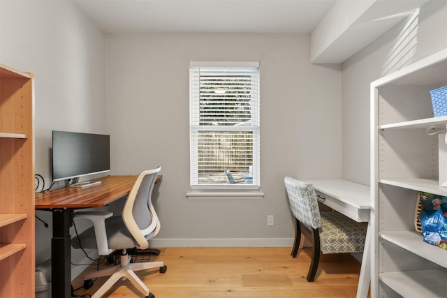 home office featuring light wood-style flooring and baseboards