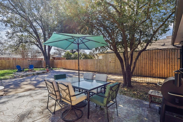 view of patio with outdoor dining space and a fenced backyard