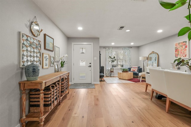 entrance foyer with light wood-style flooring, visible vents, baseboards, and recessed lighting