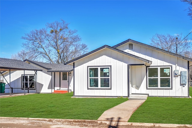 modern farmhouse featuring roof with shingles, board and batten siding, and a front yard