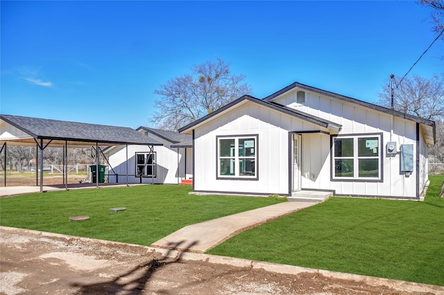 modern farmhouse style home featuring board and batten siding and a front yard