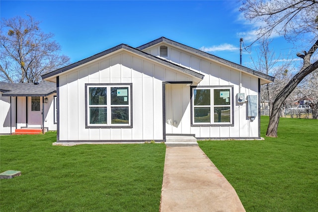 modern inspired farmhouse with a front lawn and board and batten siding