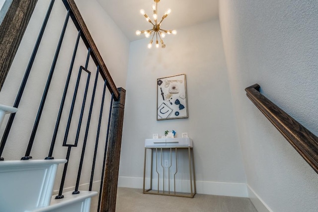 stairs with carpet floors, baseboards, and a notable chandelier