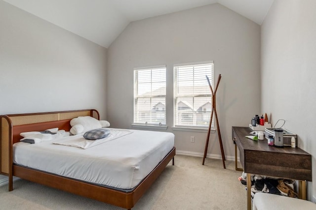 bedroom with light carpet, vaulted ceiling, and baseboards