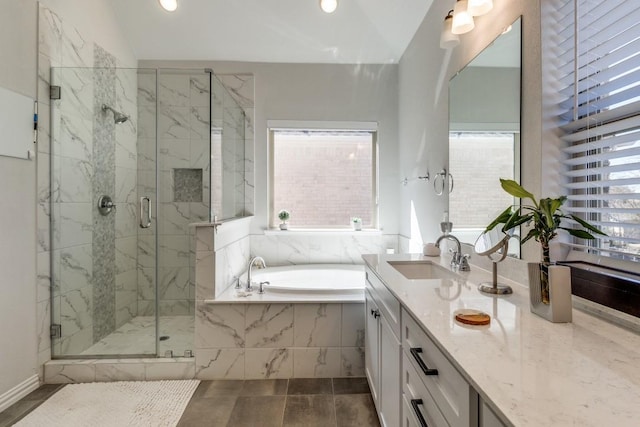 full bathroom featuring lofted ceiling, vanity, a marble finish shower, and a bath