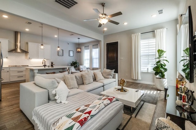 living room featuring dark wood finished floors, visible vents, and recessed lighting