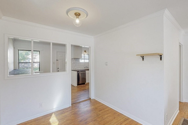 interior space with ornamental molding, light wood finished floors, and plenty of natural light