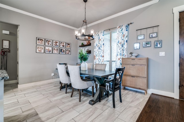 dining space with a chandelier, light wood-type flooring, crown molding, and baseboards