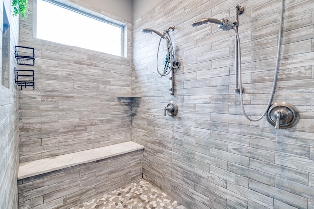 full bath with a tile shower