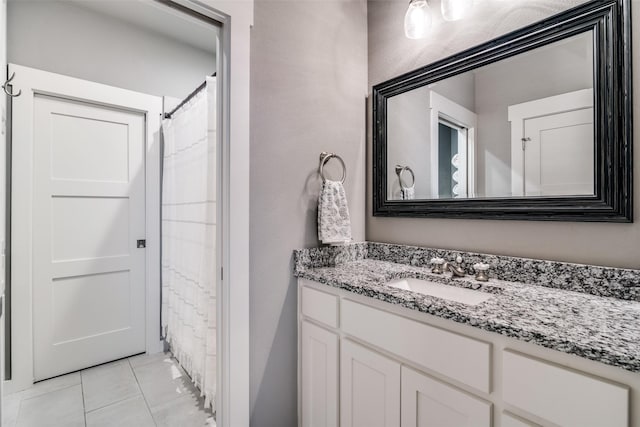 full bathroom featuring vanity and tile patterned floors