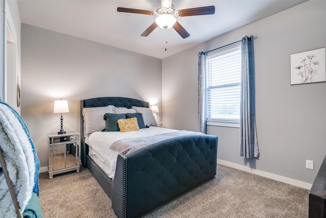 bedroom with ceiling fan, baseboards, and light colored carpet