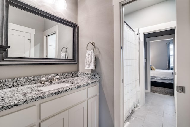 bathroom featuring vanity, ensuite bathroom, and tile patterned floors