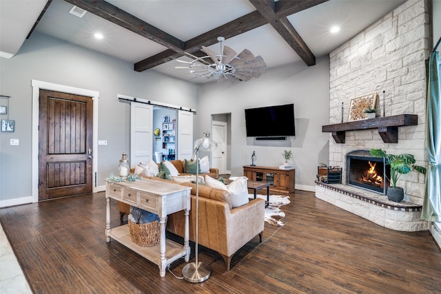 living area featuring wood finished floors, beamed ceiling, baseboards, and a barn door