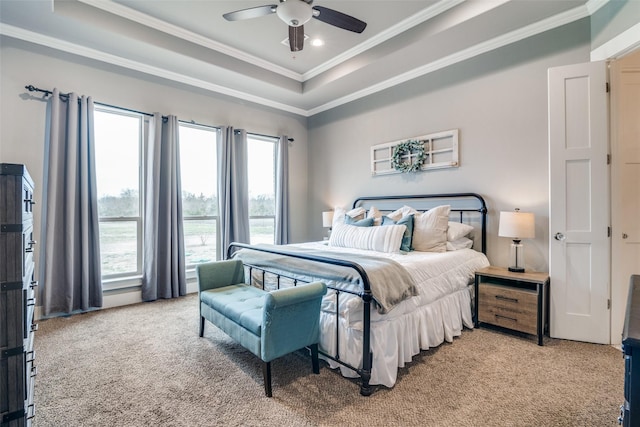 bedroom with ceiling fan, a raised ceiling, crown molding, and light colored carpet