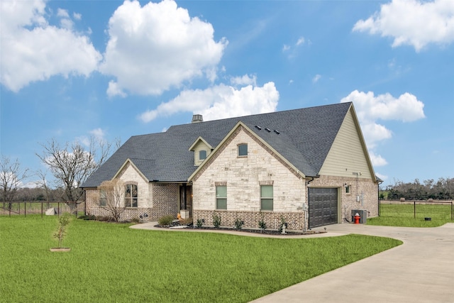 view of front of property with fence, concrete driveway, and a front yard