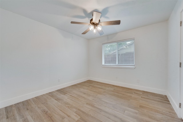 empty room with light wood finished floors, ceiling fan, and baseboards