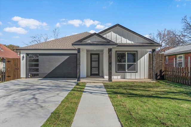 view of front of home featuring driveway, an attached garage, fence, and board and batten siding