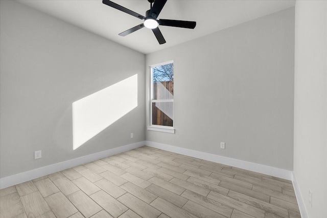 spare room with ceiling fan, baseboards, and wood finish floors