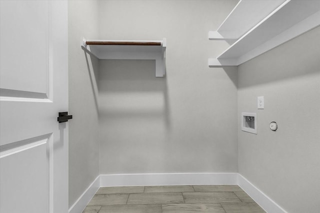 clothes washing area featuring baseboards, laundry area, hookup for a washing machine, and hookup for a gas dryer