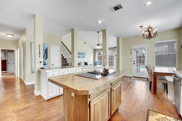 kitchen with a center island, light wood finished floors, visible vents, open floor plan, and black electric cooktop