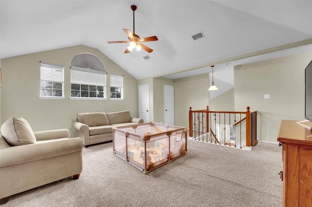 carpeted living room with lofted ceiling, ceiling fan, and visible vents