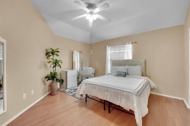 bedroom featuring lofted ceiling, ceiling fan, baseboards, and wood finished floors