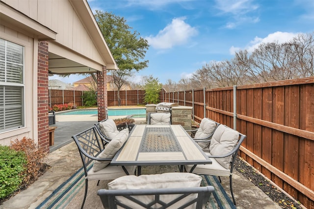 view of patio / terrace featuring a fenced in pool, outdoor dining area, and a fenced backyard