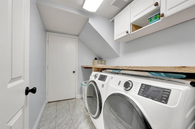 clothes washing area featuring marble finish floor, washing machine and clothes dryer, visible vents, cabinet space, and baseboards