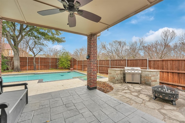 view of patio with a fenced backyard, a fire pit, exterior kitchen, grilling area, and a fenced in pool