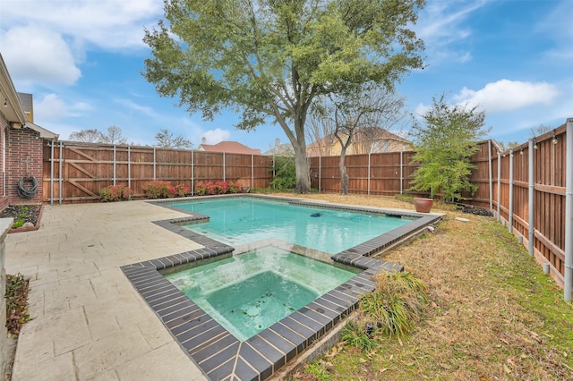 view of pool featuring a patio, a fenced backyard, and a pool with connected hot tub