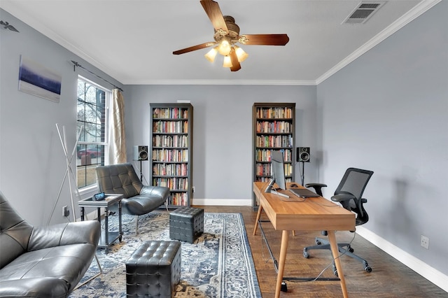 office space with ornamental molding, visible vents, and baseboards