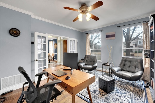 office area featuring visible vents, baseboards, a ceiling fan, wood finished floors, and crown molding